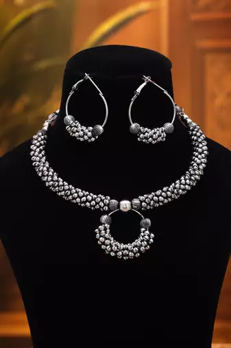 Graceful royal silver color oxidised necklace set styled for traditional saree pairing