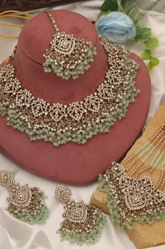 Pastel pista green color kundan necklace set tailored for daytime sangeet functions