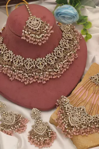 Charming baby light pink color kundan necklace set created for festive celebrations