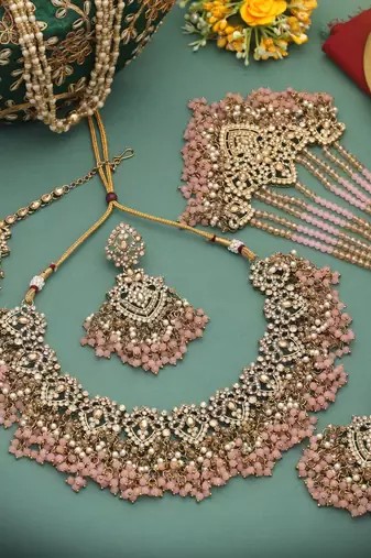 Charming baby light pink color kundan necklace set created for festive celebrations