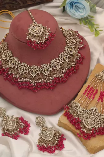 Vivid royal rani color kundan necklace set styled for traditional bridal attire
