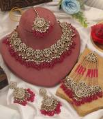 Vivid royal rani color kundan necklace set styled for traditional bridal attire