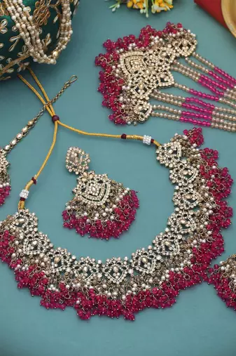 Vivid royal rani color kundan necklace set styled for traditional bridal attire