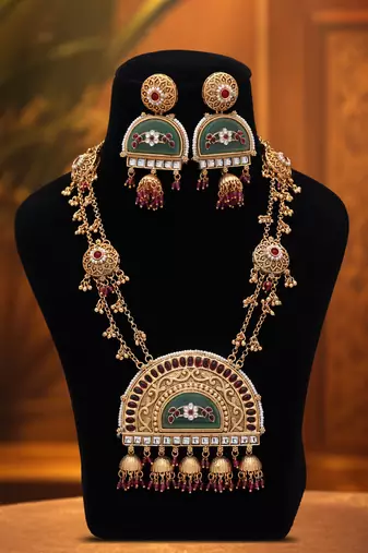 Vibrant rani color matte gold necklace set paired with dangle earrings