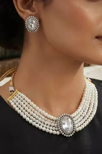 Pristine diamond white color stone necklace set styled for formal evening parties