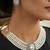 Pristine diamond white color stone necklace set styled for formal evening parties