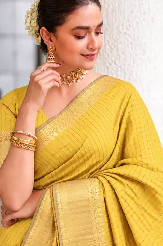 Women's yellow & golden zari woven kanjivaram style silk blend saree with blouse piece