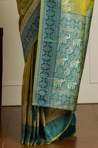Green woven design banarasi saree with blouse piece