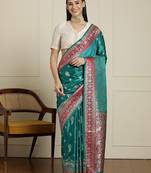 Sea green ethnic motifs zari woven design banarasi saree with blouse piece