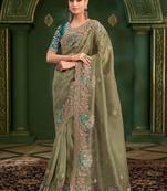Green embroidered festive wear saree with matching unstitched blouse