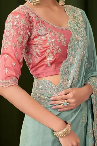 Blue embellished festive wear saree with matching unstitched blouse