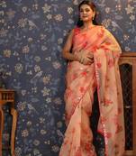 Peach floral printed organza embellished border saree