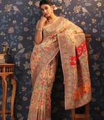 Cream woven design banarasi saree with blouse piece