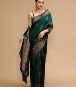 Green ethnic motifs woven design zari banarasi saree