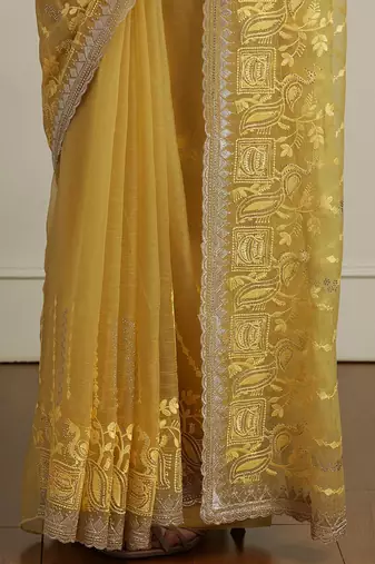 Yellow women ethnic motifs embroidered saree