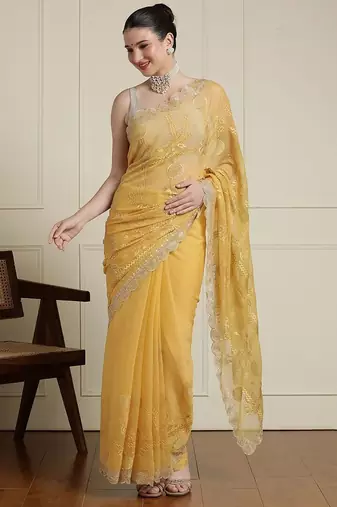 Yellow ethnic motifs embroidered scallop zari border saree