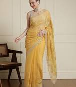 Yellow ethnic motifs embroidered scallop zari border saree