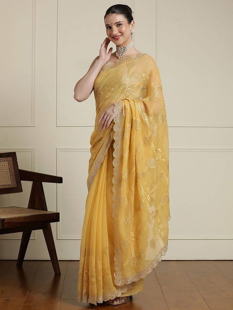 Yellow ethnic motifs embroidered scallop zari border saree