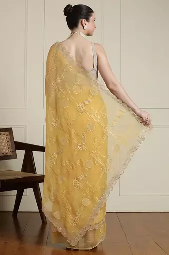 Yellow ethnic motifs embroidered scallop zari border saree