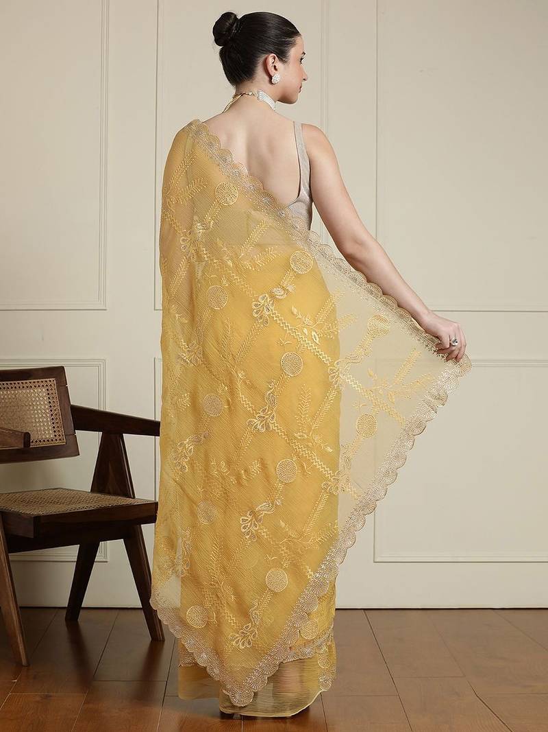 Yellow ethnic motifs embroidered scallop zari border saree