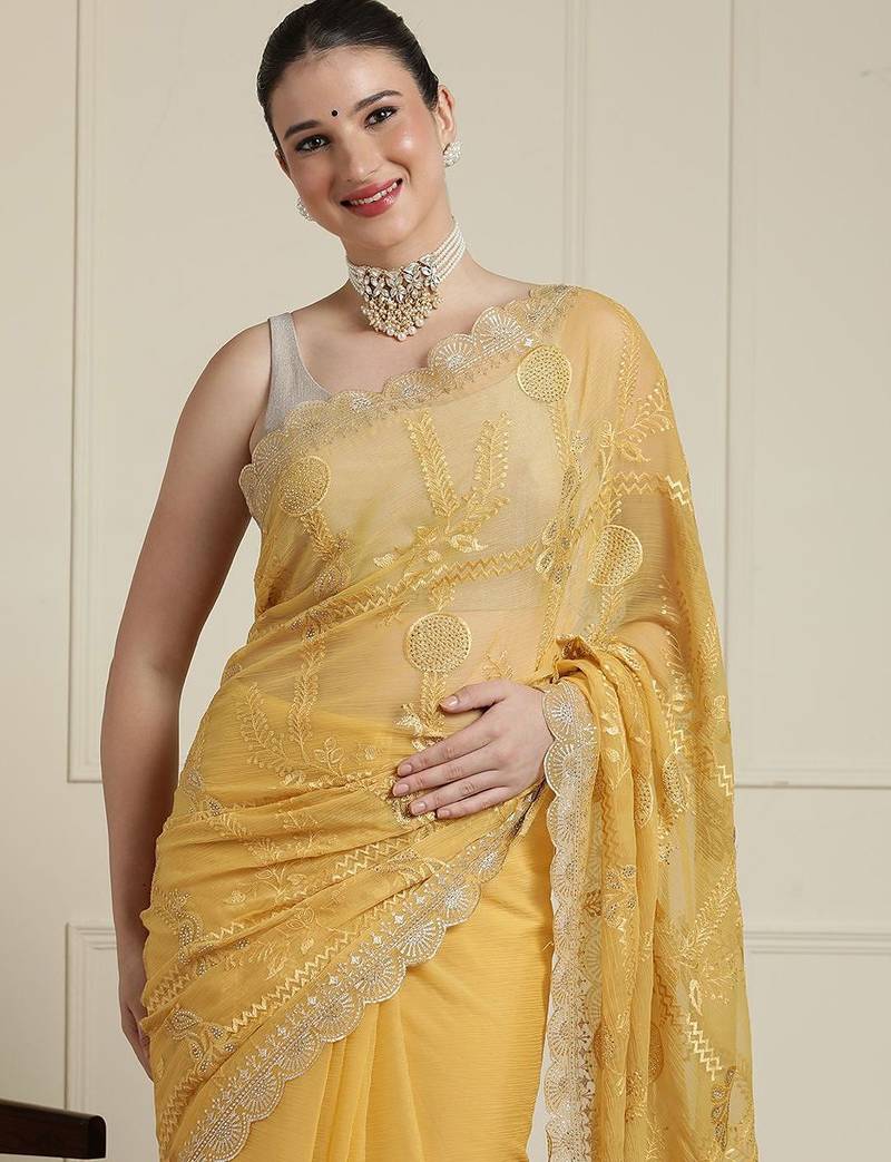 Yellow ethnic motifs embroidered scallop zari border saree
