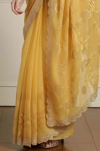 Yellow ethnic motifs embroidered scallop zari border saree