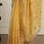 Yellow ethnic motifs embroidered scallop zari border saree