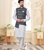Maroon kurta and trousers paired with blue waistcoat featuring an intricate red pattern, gold-tone buttons