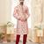 A soft peach kurta with scattered red floral motifs and striped detailing along the collar, placket, and cuffs