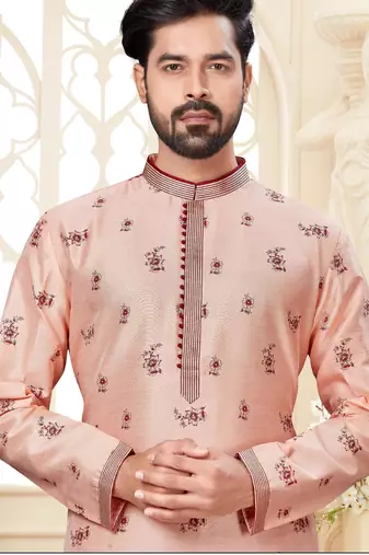 A soft peach kurta with scattered red floral motifs and striped detailing along the collar, placket, and cuffs