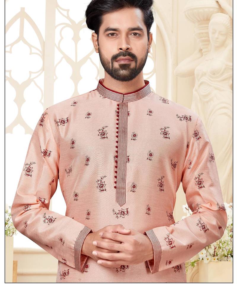 A soft peach kurta with scattered red floral motifs and striped detailing along the collar, placket, and cuffs