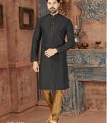 A black printed kurta with a subtle gold geometric pattern and gold detailing on the collar, placket, and cuffs, paired