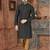 A black printed kurta with a subtle gold geometric pattern and gold detailing on the collar, placket, and cuffs, paired