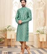 A teal blue printed kurta with repeating floral medallions in muted gold and rust, finished