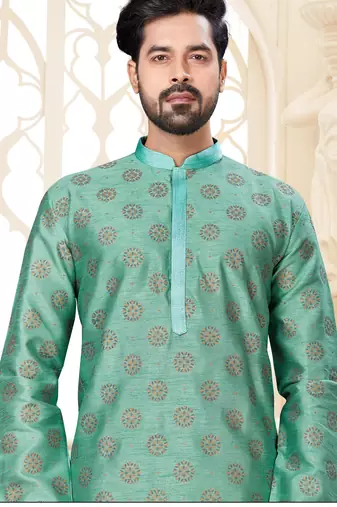A teal blue printed kurta with repeating floral medallions in muted gold and rust, finished