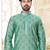 A teal blue printed kurta with repeating floral medallions in muted gold and rust, finished