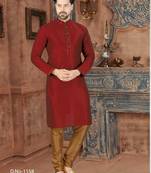 A rich maroon printed kurta with a subtle geometric pattern and fine gold detailing along the collar, placket, and cuffs