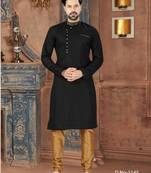 Black kurta with a subtle textured finish, featuring an asymmetrical line of gold-tone buttons.