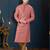 Dusty-rose kurta with a subtle textured finish and ornate contrasting trim along the collar and placket