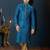 Teal-blue kurta with a subtle jacquard pattern and fine gold piping on the collar, placket and cuffs