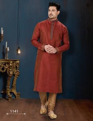 Rust-red kurta with a subtle all-over pattern and ornate gold-toned trim along the collar, placket and cuffs 1