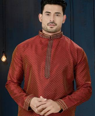 Rust-red kurta with a subtle all-over pattern and ornate gold-toned trim along the collar, placket and cuffs 2