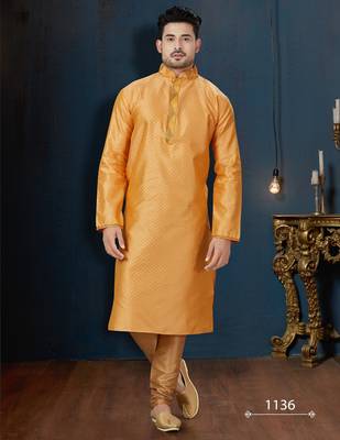 Mustard-gold kurta with a subtle tonal pattern and a contrasting gold placket, styled with matching trousers. 1