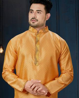 Mustard-gold kurta with a subtle tonal pattern and a contrasting gold placket, styled with matching trousers. 2