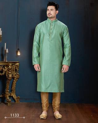 Sea-green kurta with an elegant tonal jacquard pattern, stand collar and gold-buttons, paired with gold trousers. 1