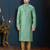 Sea-green kurta with an elegant tonal jacquard pattern, stand collar and gold-buttons, paired with gold trousers.
