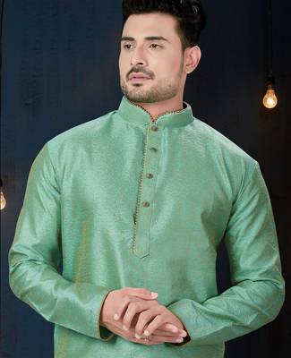 Sea-green kurta with an elegant tonal jacquard pattern, stand collar and gold-buttons, paired with gold trousers. 2