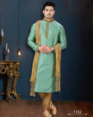Mint-green kurta with a subtle woven pattern and gold-trimmed collar, placket and cuffs, paired with gold trousers. 1