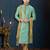 Mint-green kurta with a subtle woven pattern and gold-trimmed collar, placket and cuffs, paired with gold trousers.