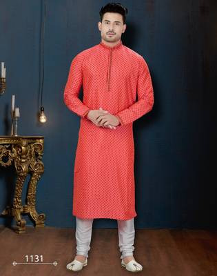 Coral-pink kurta with a subtle along the collar,placket and cuffs,paired with white trousers. 1